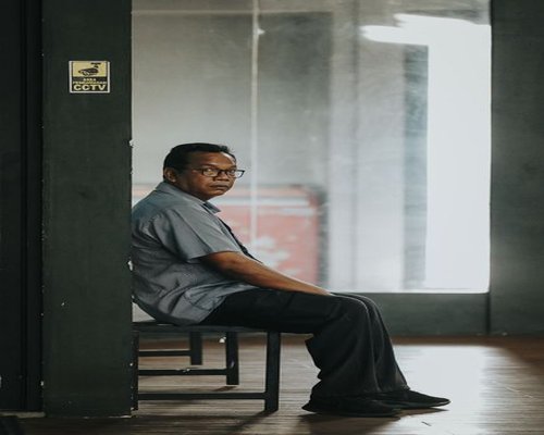 A quiet corner in a Jakarta office building with a small plant