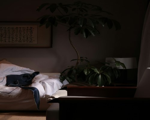 A warm lit bedroom setting emphasizing a cozy environment for resting