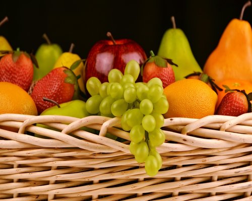 Fresh tropical fruits arranged in a traditional market basket